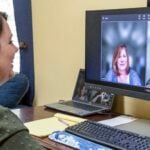 Woman video chatting on desktop computer