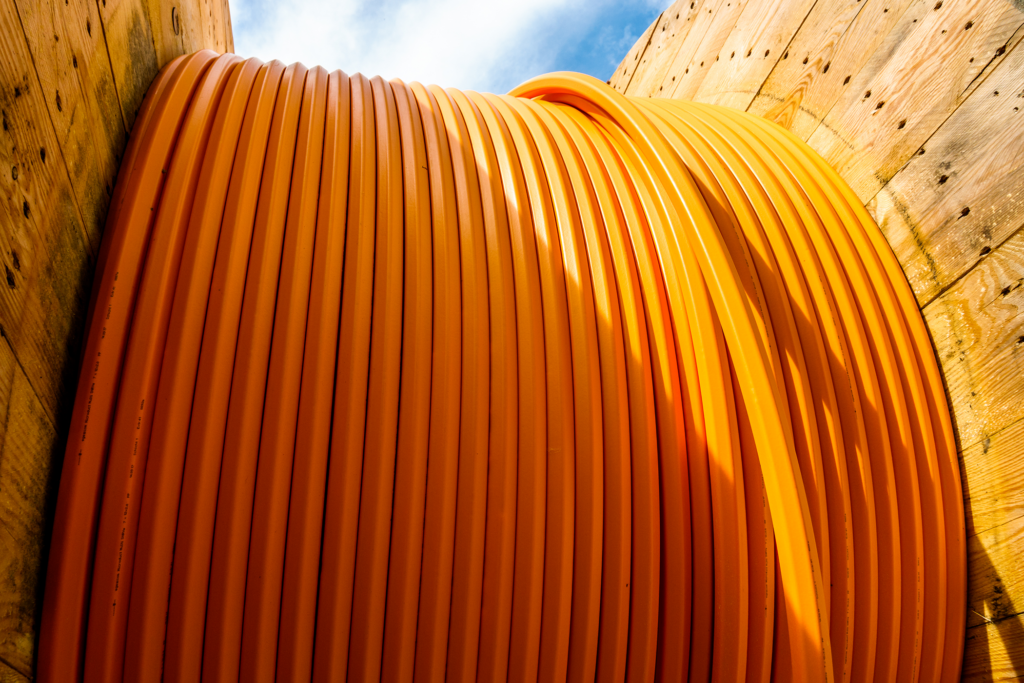 Large, orange fiber cable spool