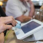 Person paying with a card at a small business