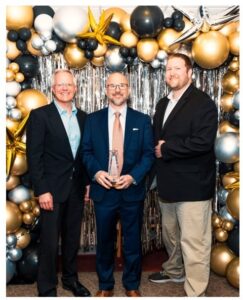 Picture of Clearwave Fiber representatives accepting the Regional Business of the Year Award from the Carbondale Chamber of Commerce. Pictured from left: Account Executive Chris Ahart, Strategic Account Representative Robert Tolnai, and Municipal Relations Manager Nathan Columbo. PHOTO CREDIT: Prescott Doll, Designs by Prescott