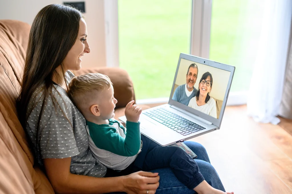 Mother and son having video call with grandparents on laptop