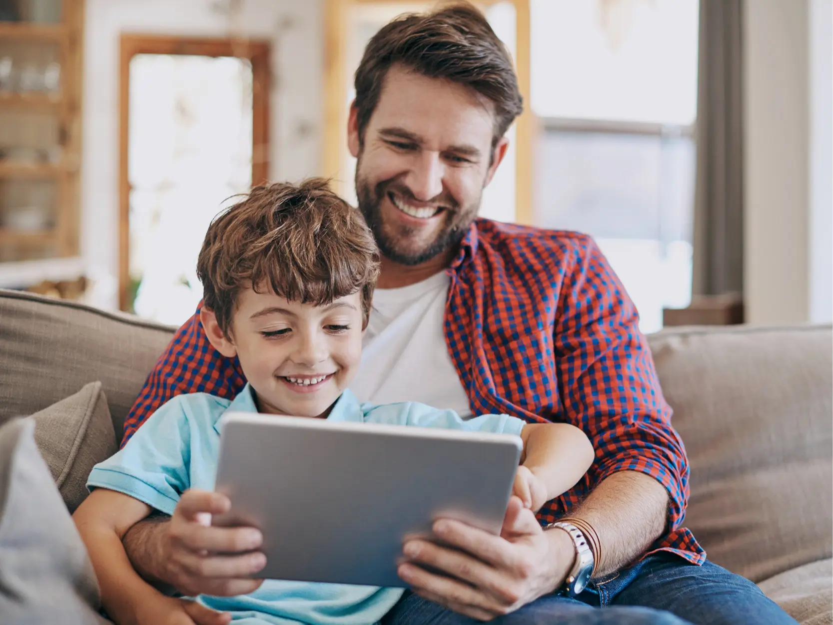 Dad and son enjoy Reliable Fiber Internet Service for Home using tablet