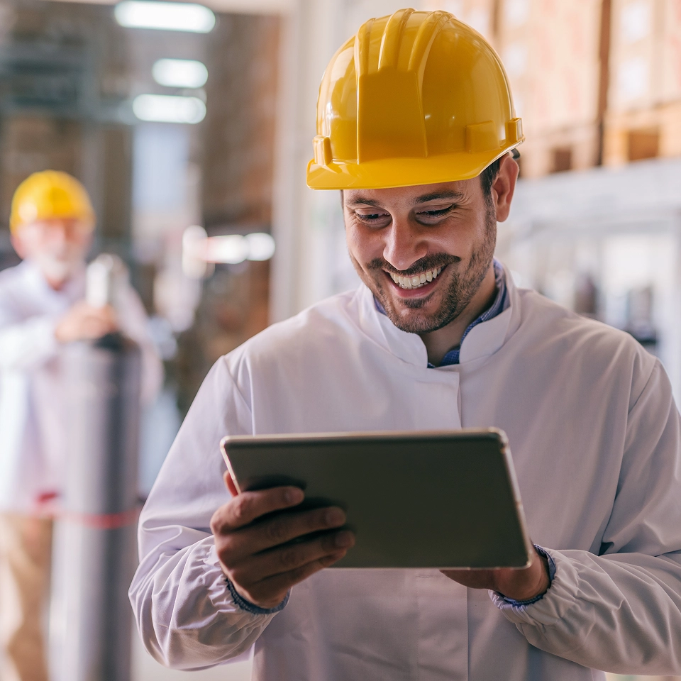 Manufacturing worker using tablet.