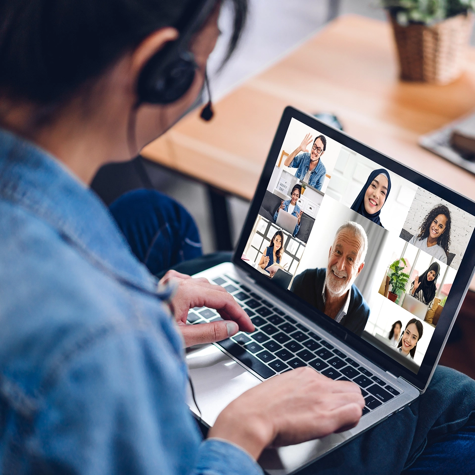 Woman using laptop for video call.